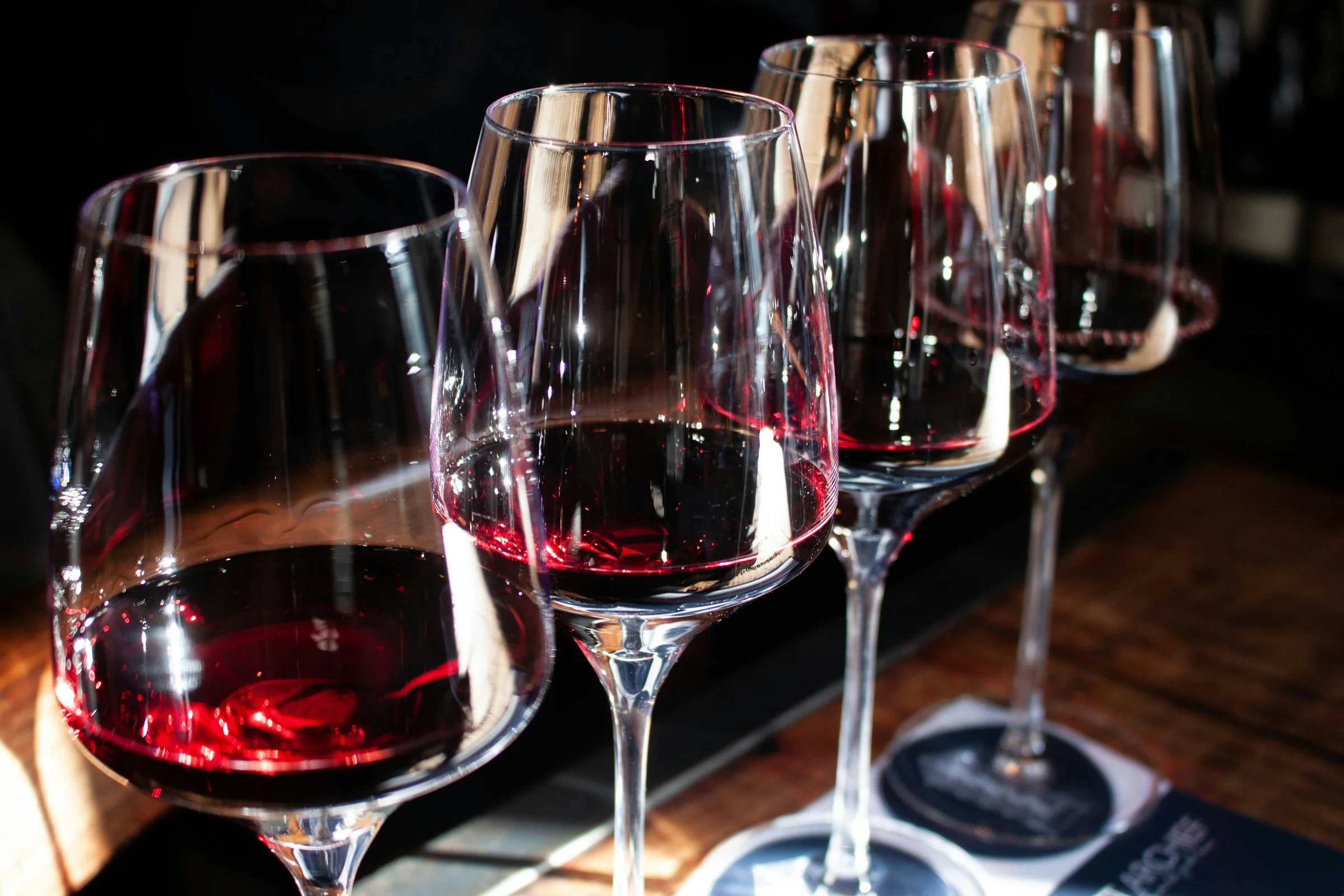 Four glasses of red wine prepared for a comparative tasting.