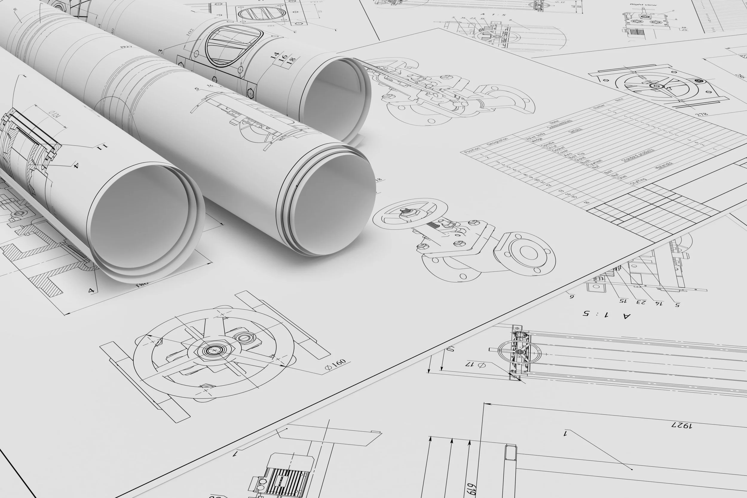 Blueprints and technical drawings of mechanical and engineering components, with rolled and laid flat sheets showing detailed schematics.