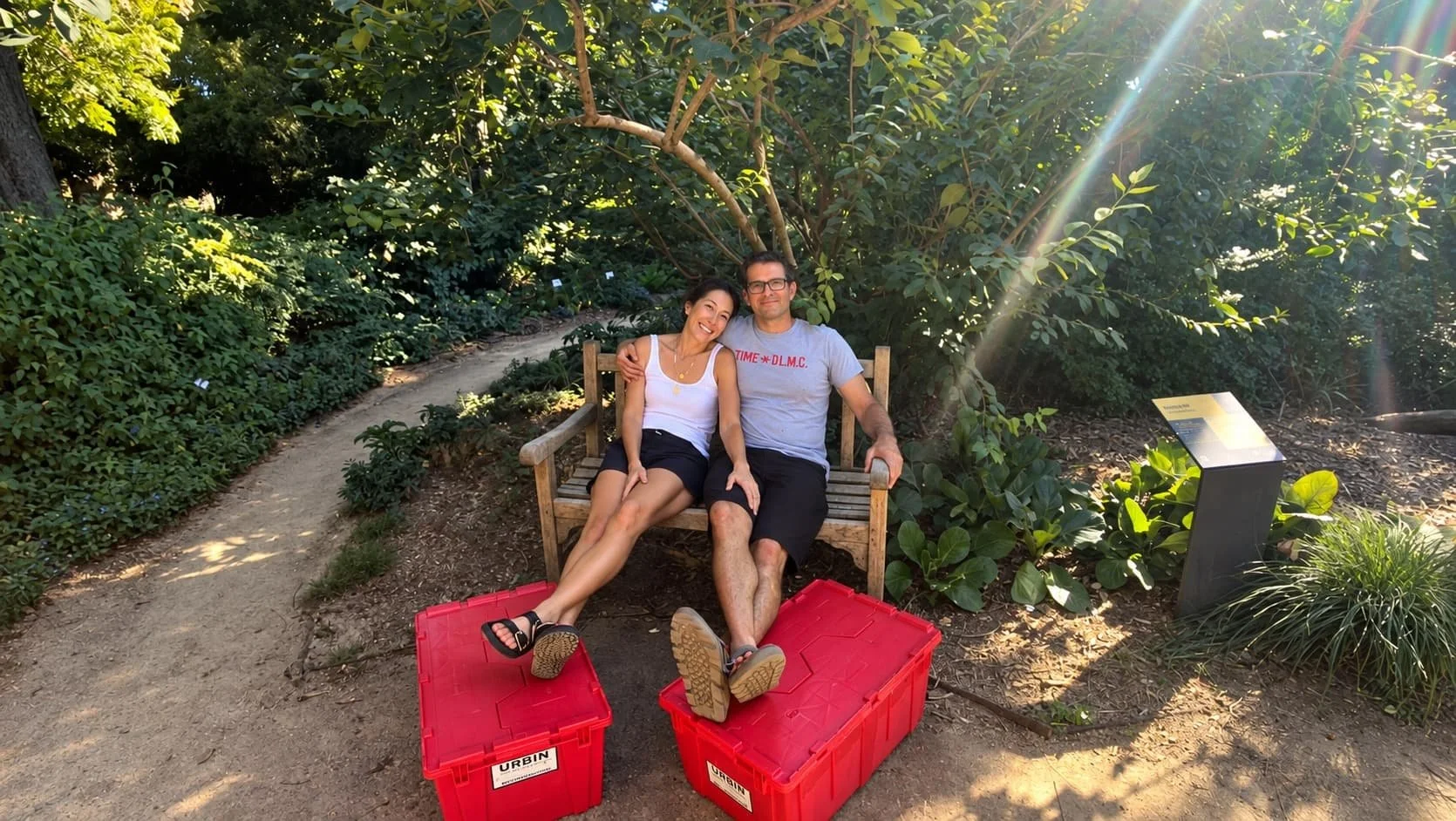 Owners of urbin move sitting on a bench with their feet on rental boxes.