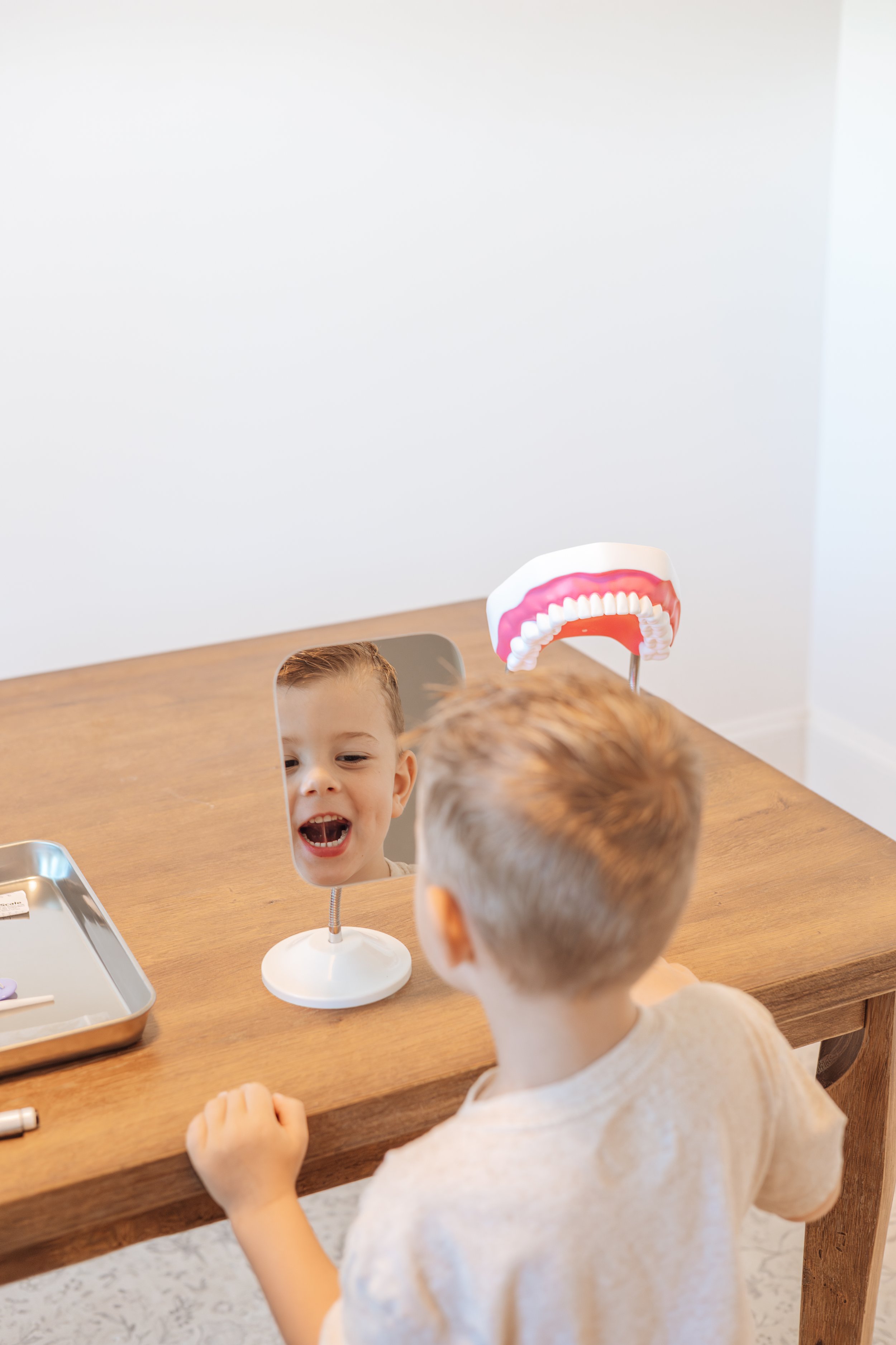 child practicing myofunctional therapy exercise