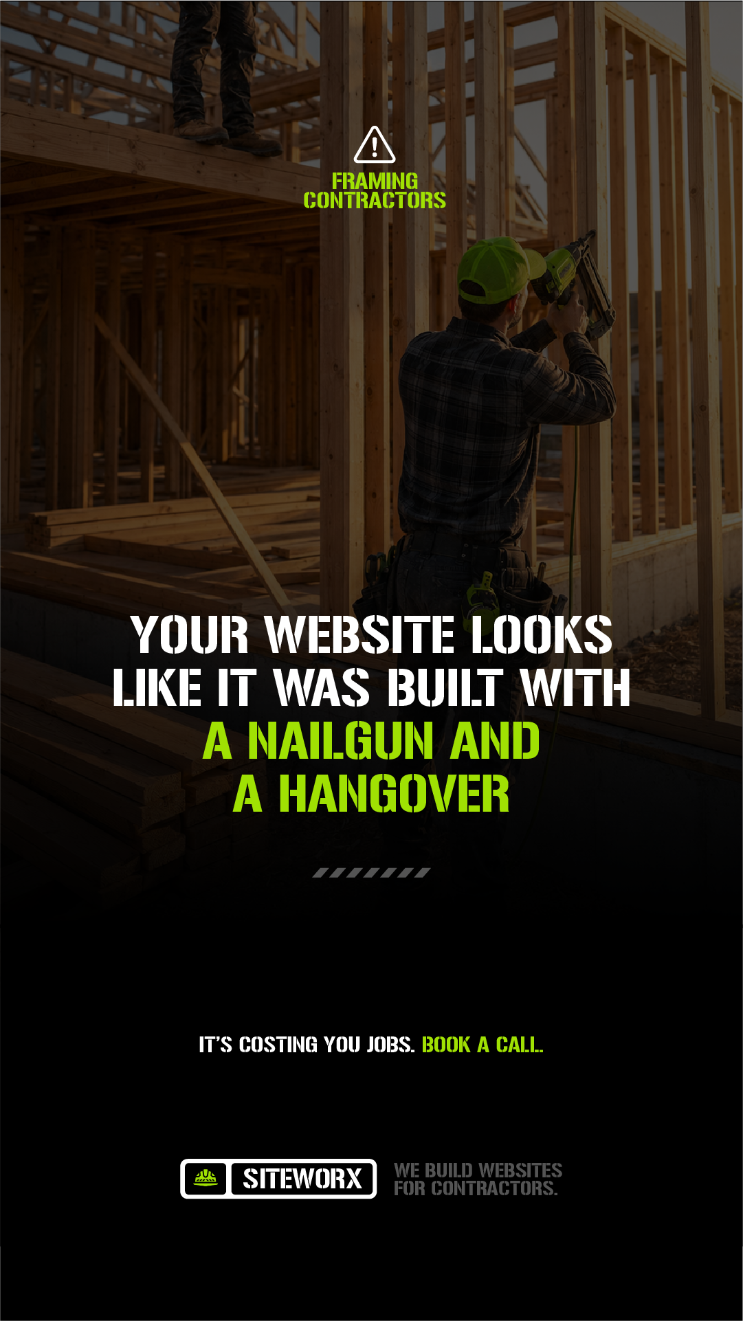 Construction worker in a yellow hard hat working on framing a building with wood studs at a construction site during sunset.