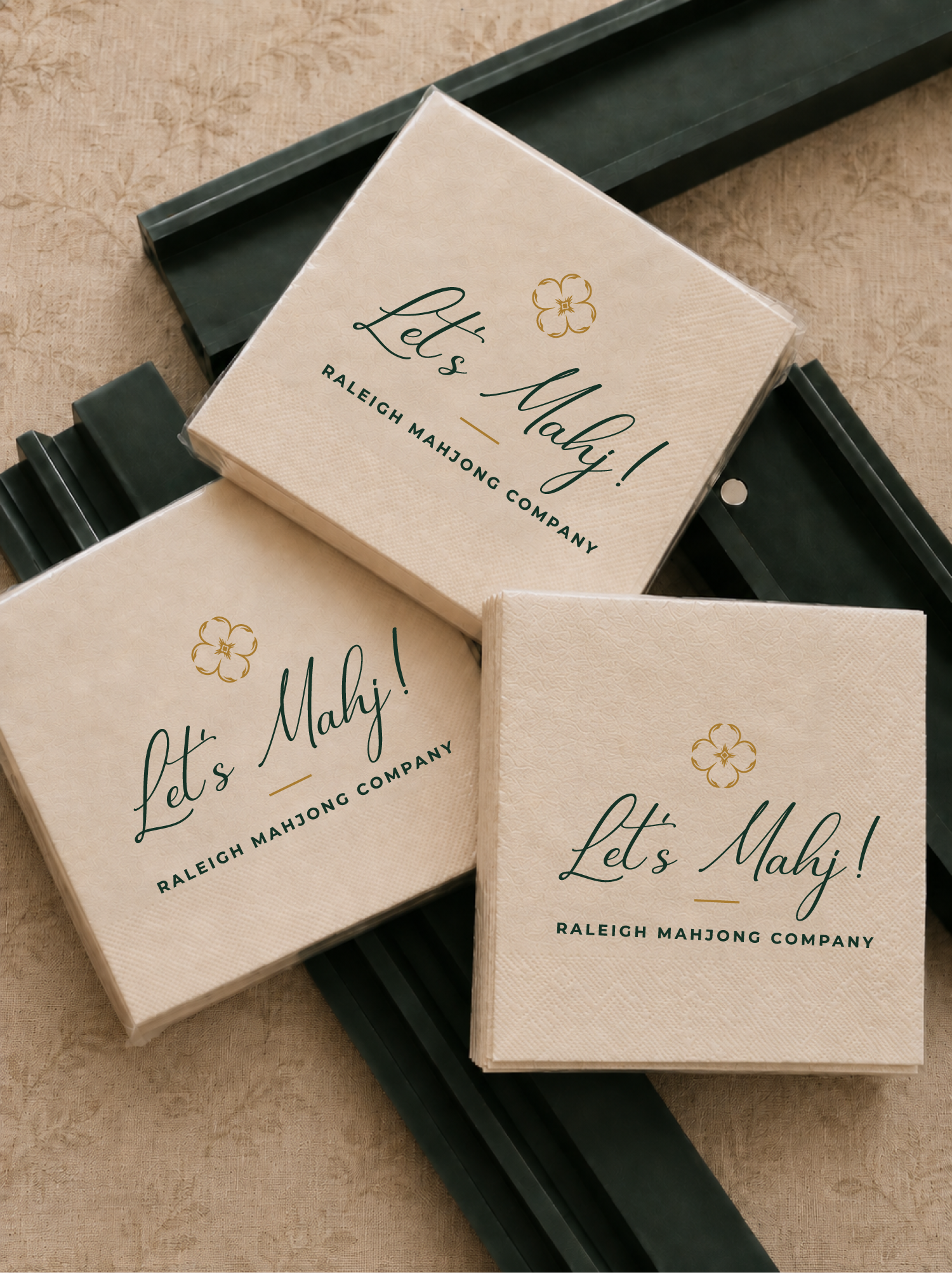 Boxes of Mahjong tiles from Raleigh Mahjong Company, with the packaging saying 'Let's Mahjong!'