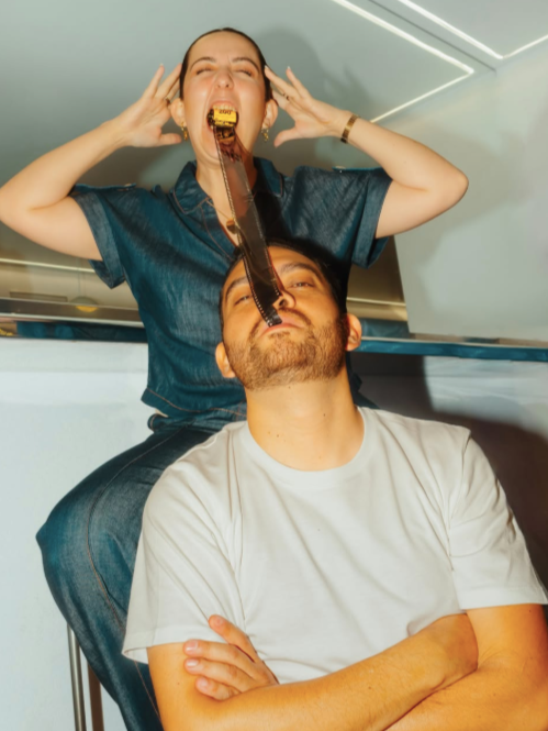 Creative editorial portrait of the video editors from Ricordo Media holding a strip of film during a lifestyle brand photoshoot by jackson grant weddings..