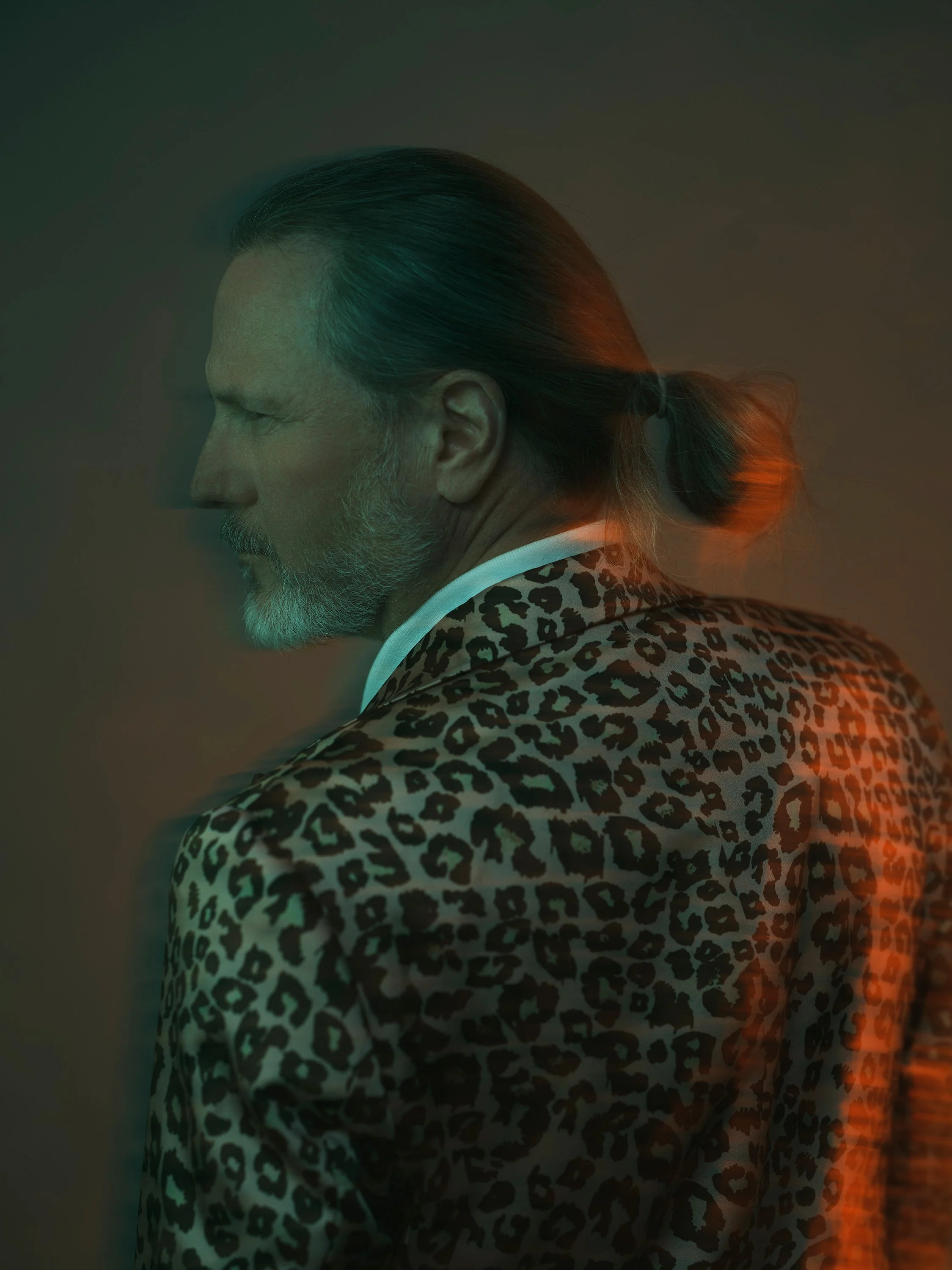 Profile portrait of a man in a leopard print jacket with motion blur lighting effect, personal work by Michael Rudin