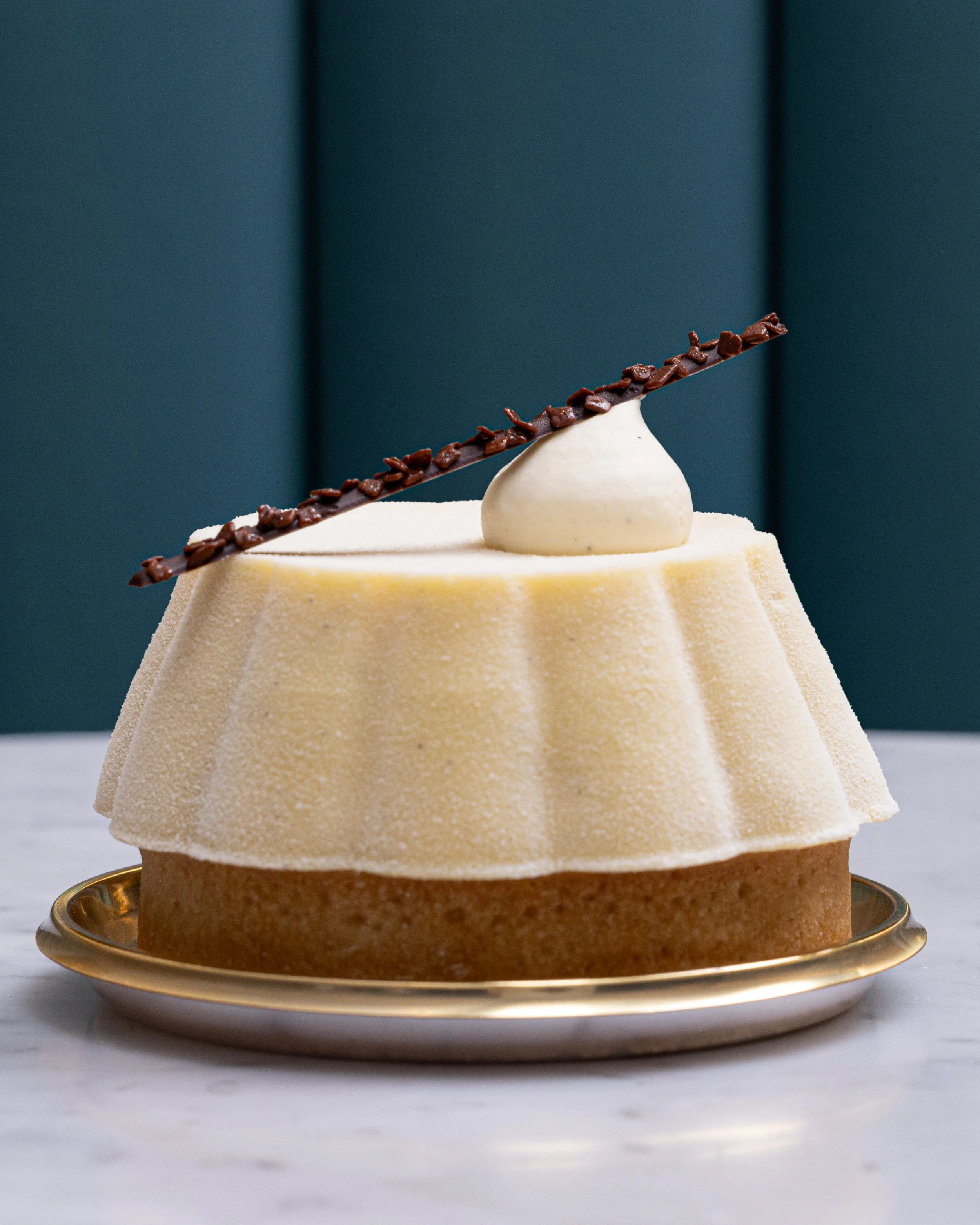Vanilla blanc tart with a chocolate tuile garnish