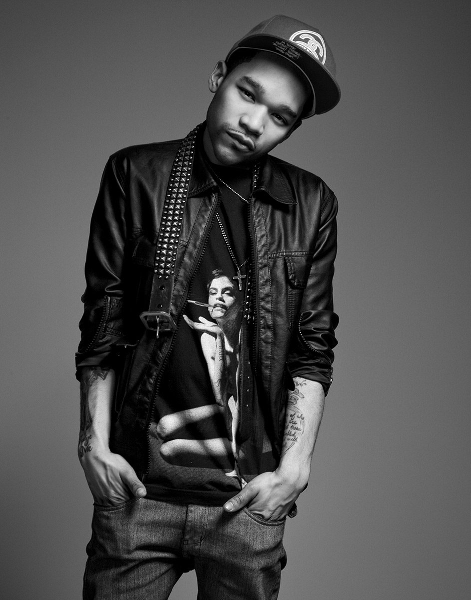 Personal portrait of stylist Carlos Nazario in a leather jacket, photographed by Michael Rudin