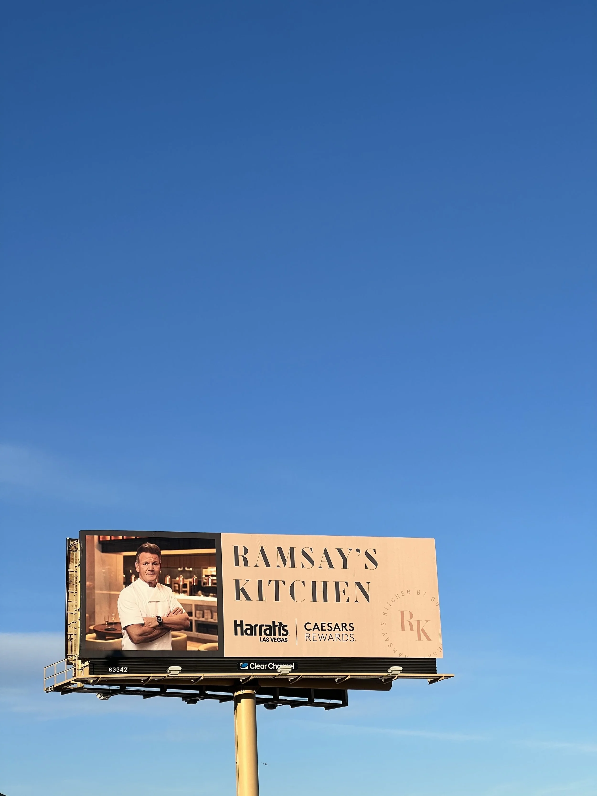 Gordon Ramsay standing in restaurant kitchen, billboard