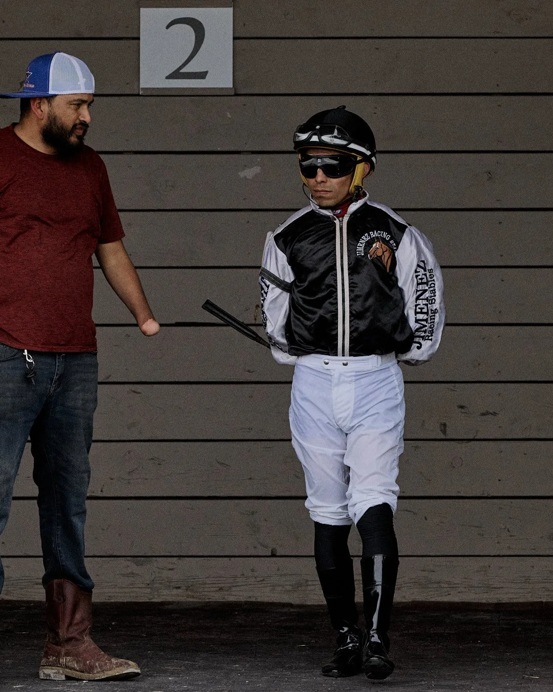 Jockey walking to the paddock with a trainer at Horseshoe Indianapolis