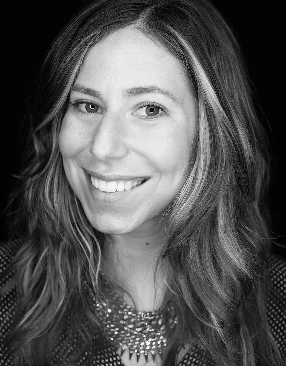 Black and white smiling personal portrait of a woman, photographed by Michael Rudin