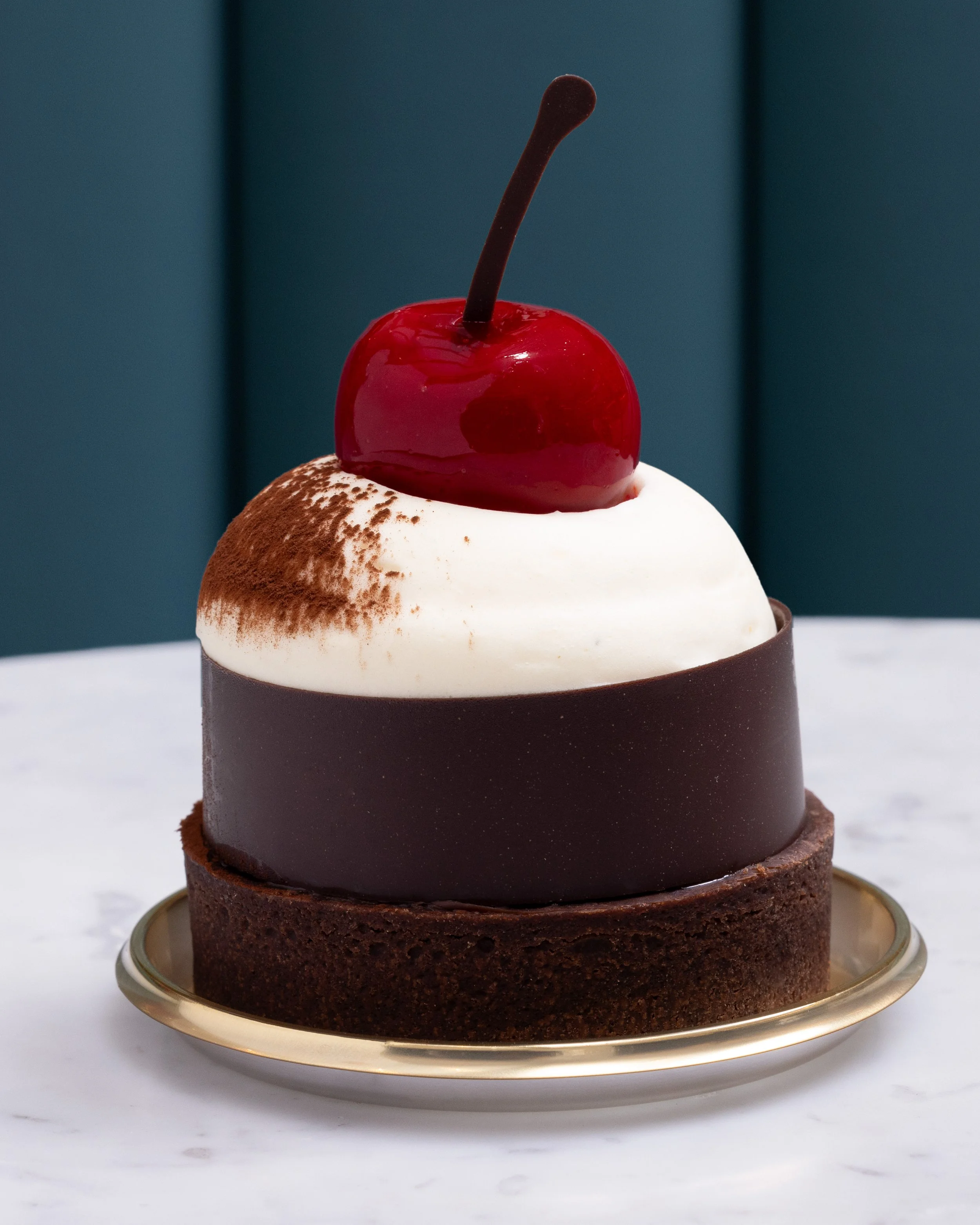 Black Forest tart topped with a glazed cherry and chocolate garnish