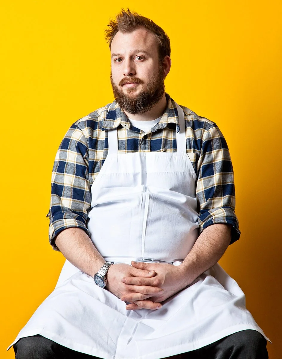 Environmental editorial portrait of a man at LIC Market, photographed by Michael Rudin