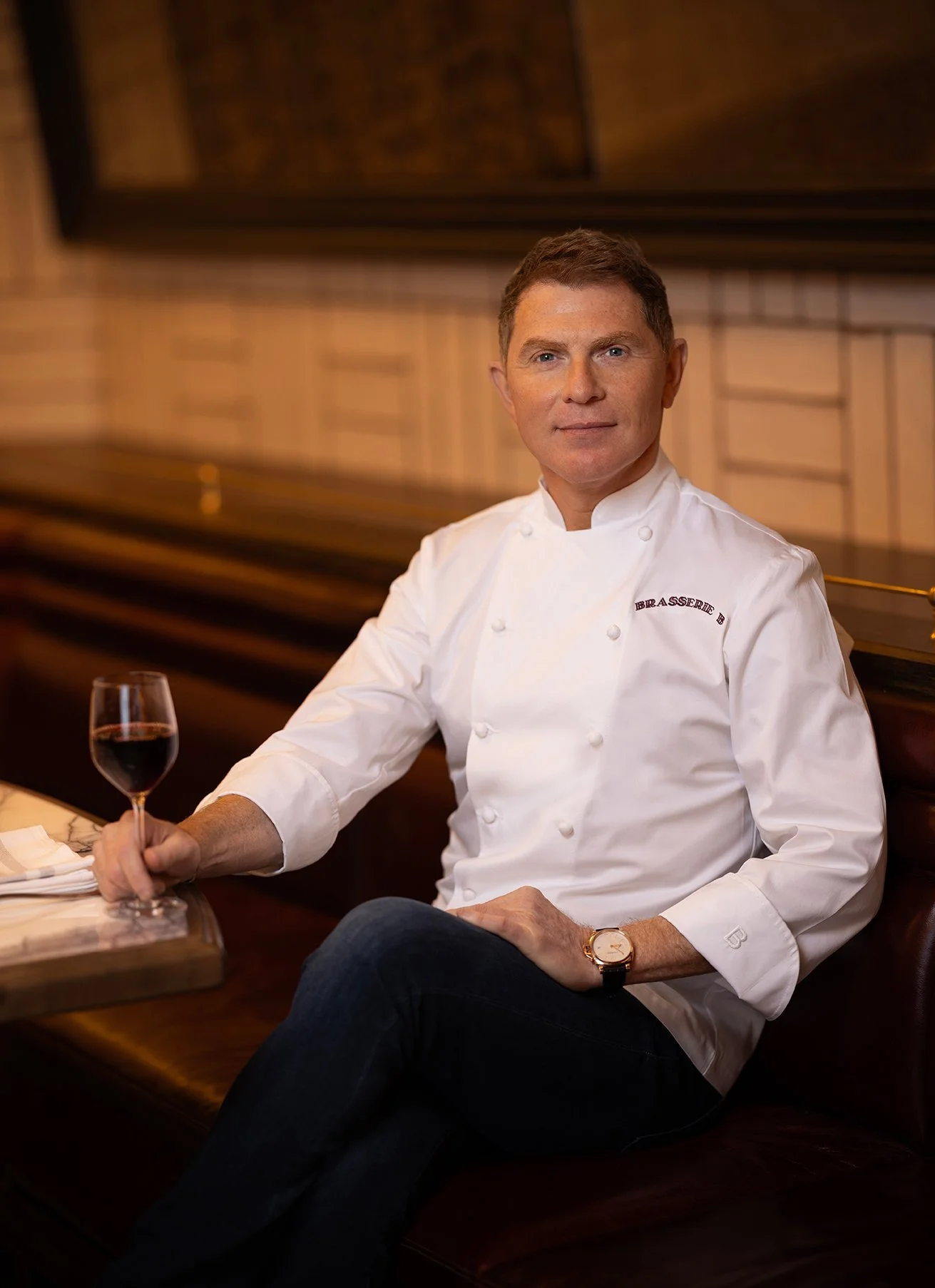 Chef Bobby Flay seated with wine glass at Brasserie B, Caesars Palace