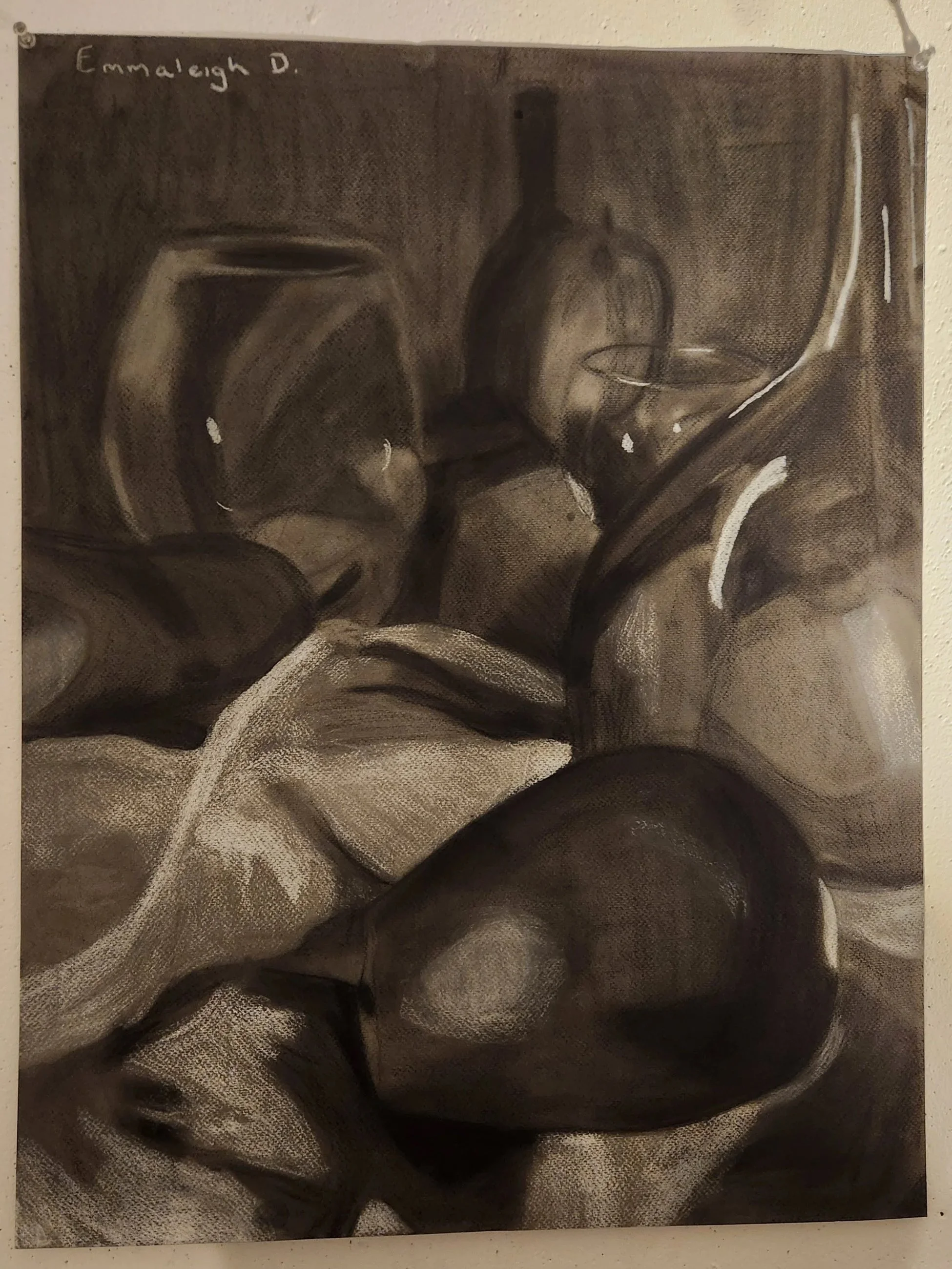 Black and white still life photograph featuring glass jars, metal tools, and a piece of cloth on a textured fabric surface.