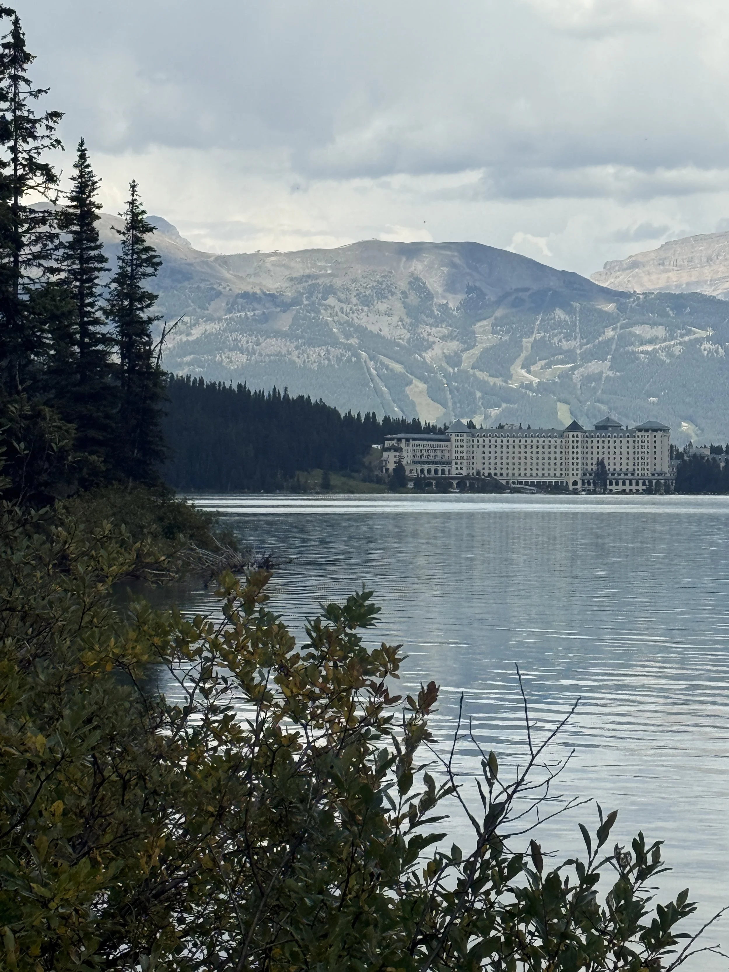 Still lake in front of a grand hotel