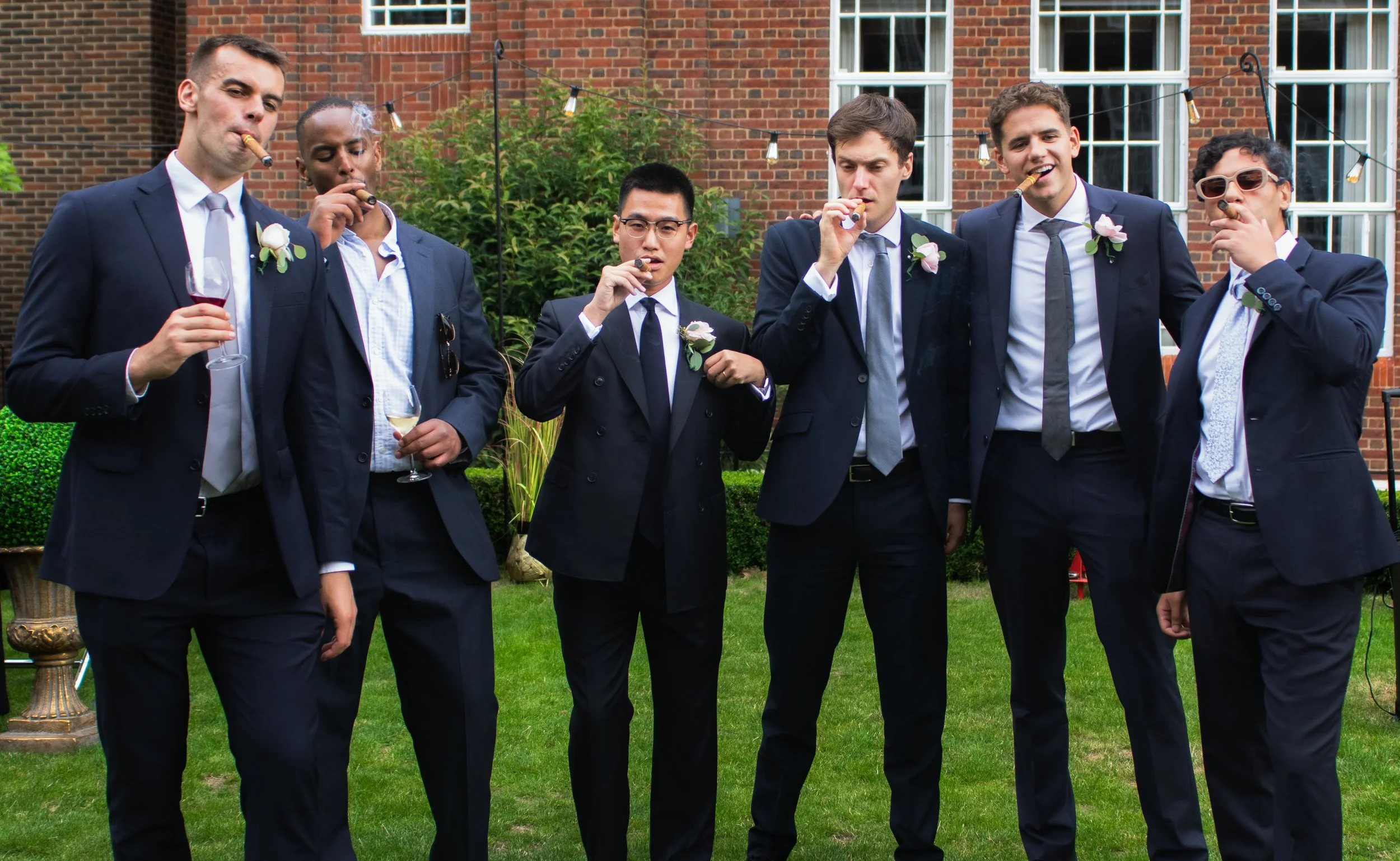 Groom and grooms men at Regents Park smoking cigars