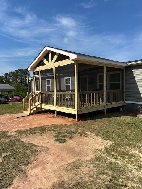 New pressure treated screened wood porch and stairs by Prime Home Improvements.