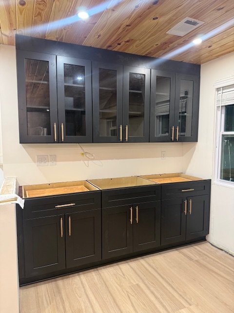 Custom black cabinet installation by Prime Home Improvements.