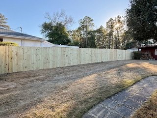 Wood privacy fence installation by Prime Home Improvements.