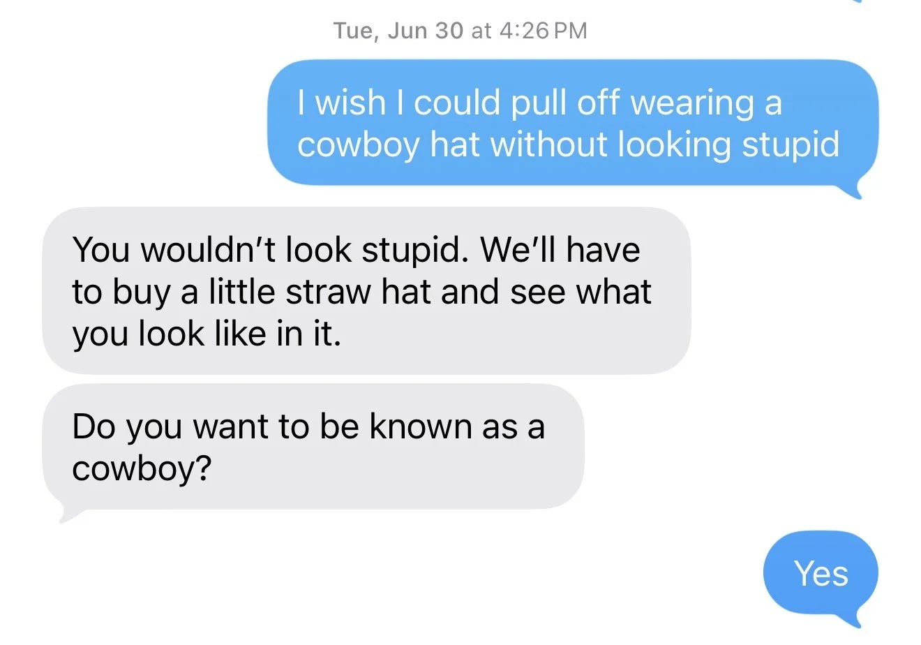 Conversation screenshot of text messages discussing wearing a cowboy hat, with one person suggesting buying a straw hat and asking if they want to be known as a cowboy.