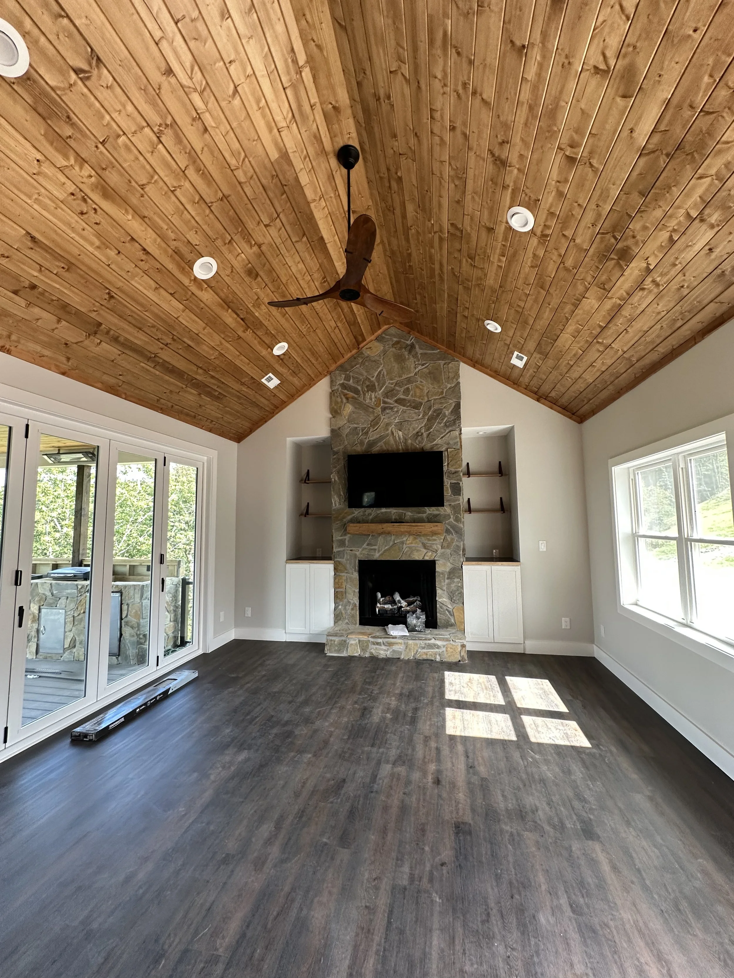 living room with fireplace and wood celling