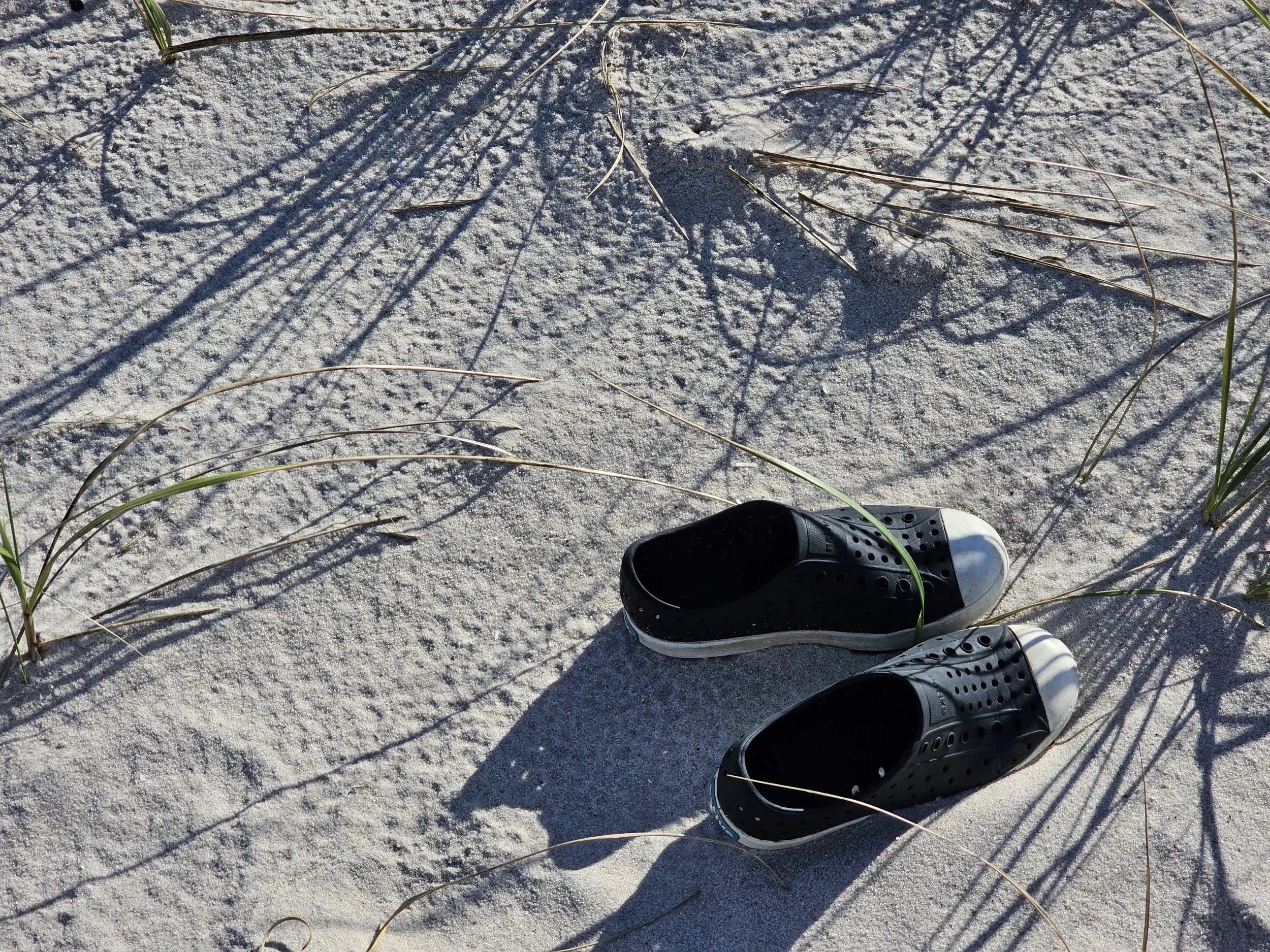 Photo of shoes on a beach by Gretchen Martens