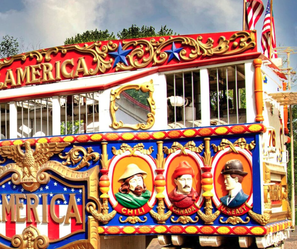 Colorful vintage carousel ride with patriotic decorations, stars, and portraits of historical figures labeled Chile, Canada, and U.S. East.