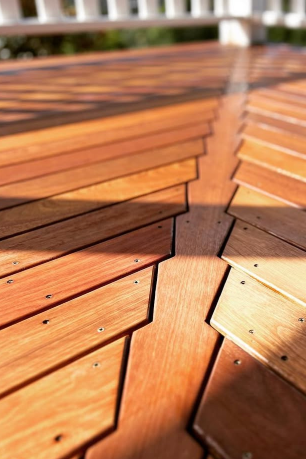 Close-up of wooden outdoor furniture with a geometric pattern designed with planks held together by screws.