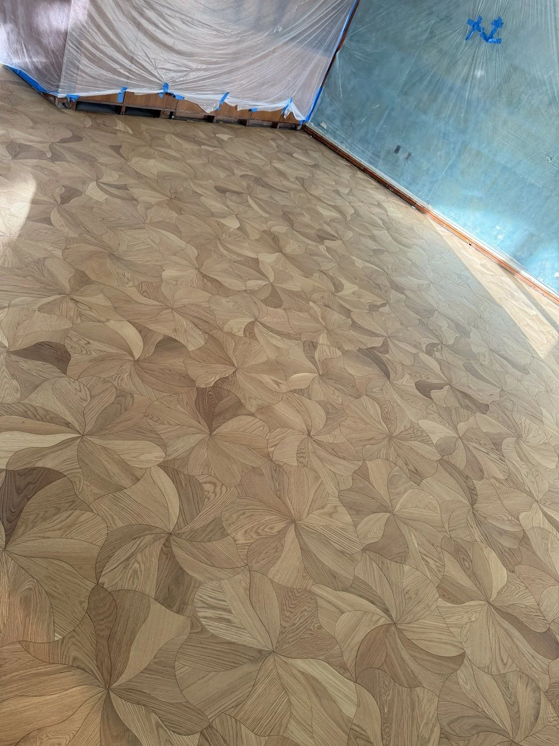 Custom floral-pattern parquet floor showcasing detailed wood craftsmanship.