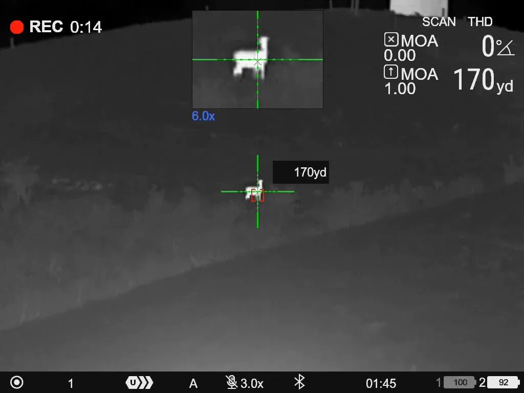 Night vision view through a thermal imaging device showing a silhouette of a deer at 170 yards. The display includes crosshairs, distance measurements, and various indicators for the thermal scope's settings.