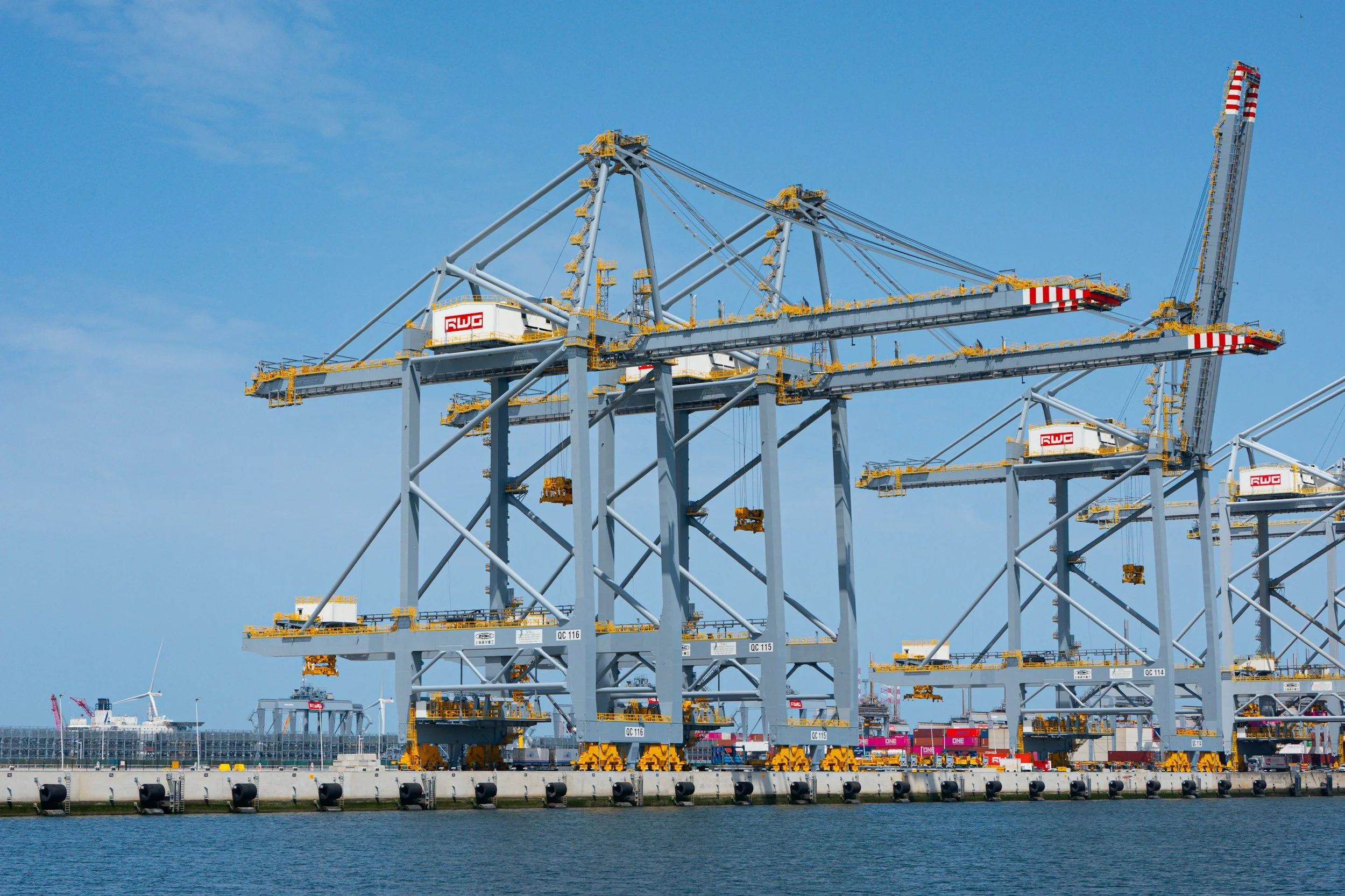 Image of large industrial port cranes on the waterfront.