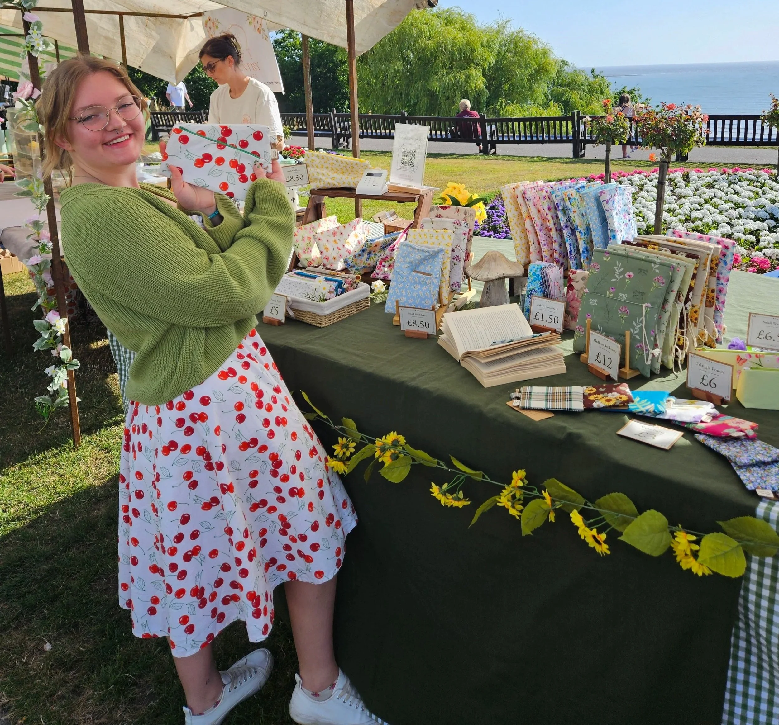 Margo with pencil cases made out of the same material as her dress, in Filey.