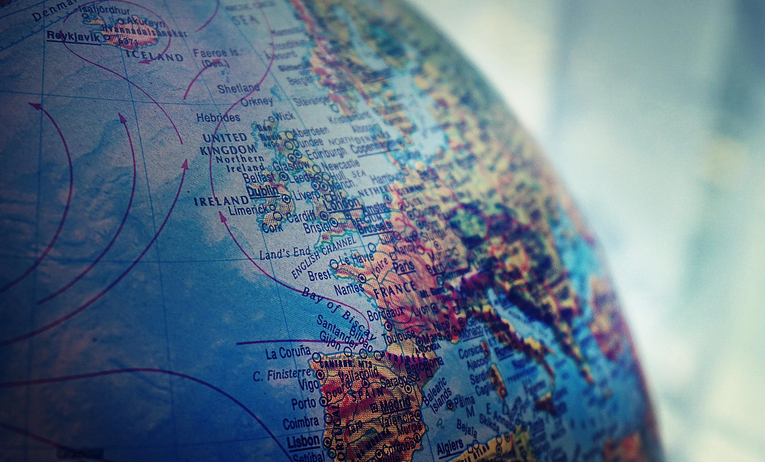 Close-up of a world globe focused on Europe, showing France, Portugal, and neighboring countries with country names, cities, and geographical boundaries.