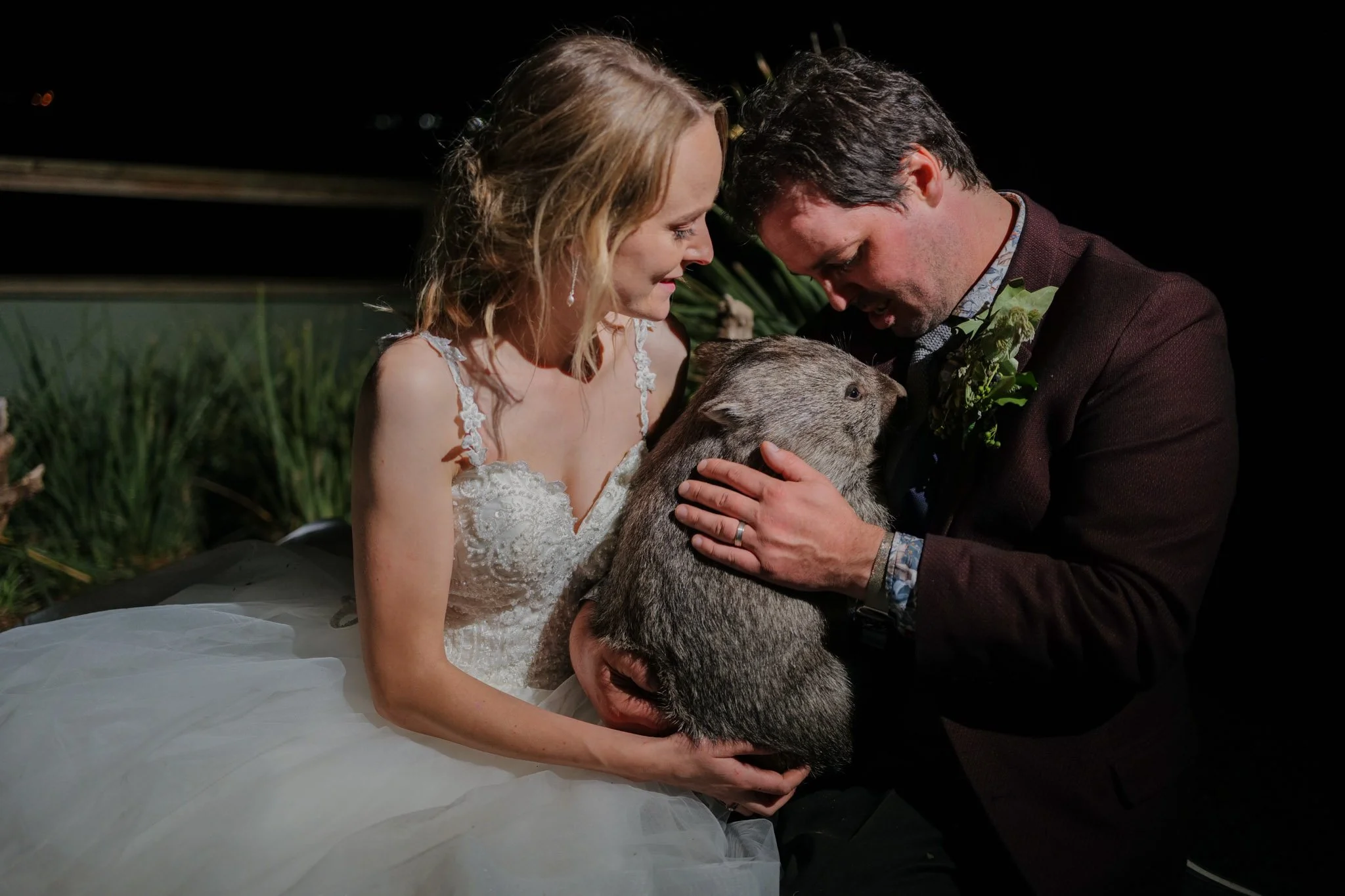 Greg Irons and Melissa Irons on their wedding day, having photos with the animals. In this case an orphaned Wombat