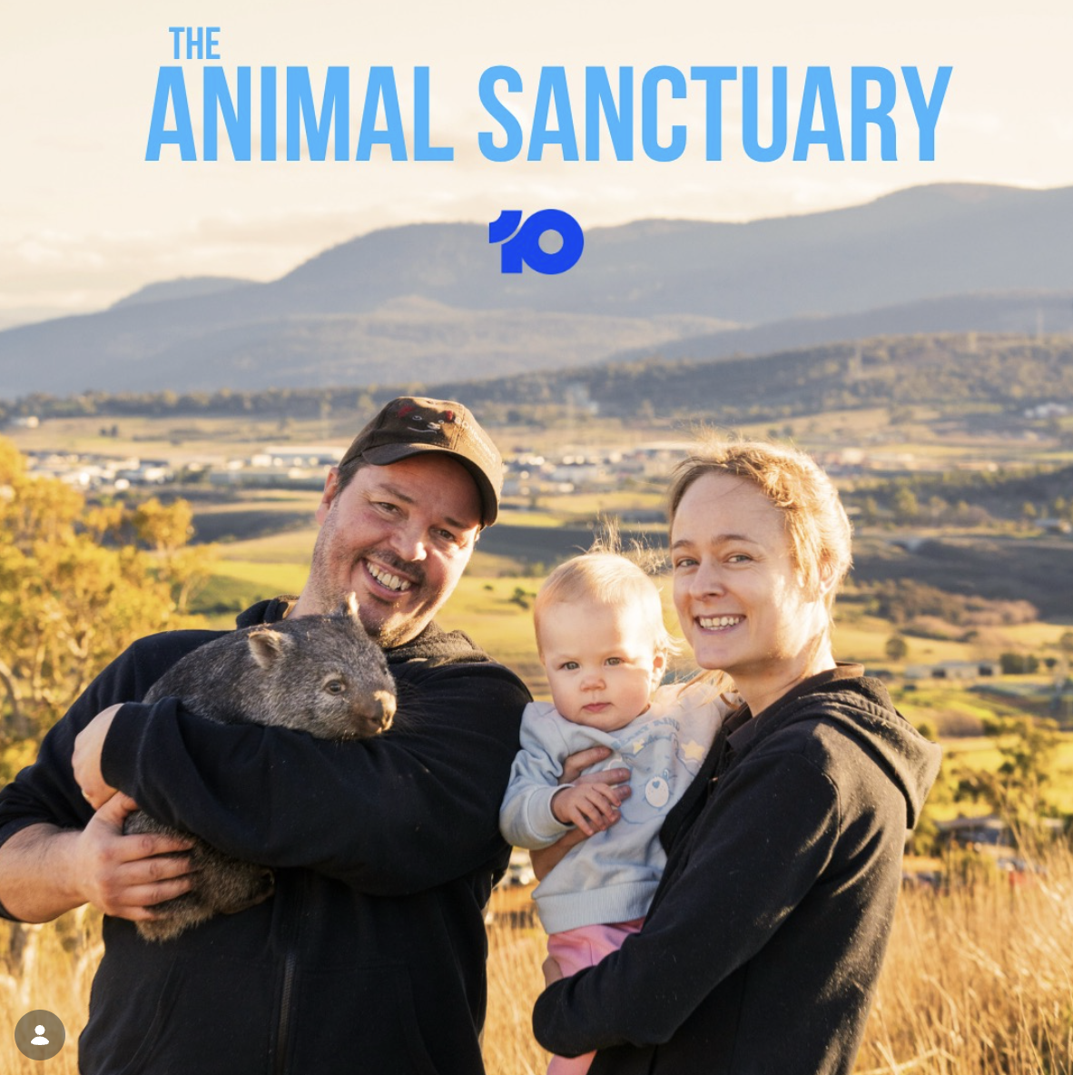 Promotional photo showing Greg Irons, Melissa Irons and Lara Irons holding a wombat with the name of the docuseries The Animal Sanctuary above them