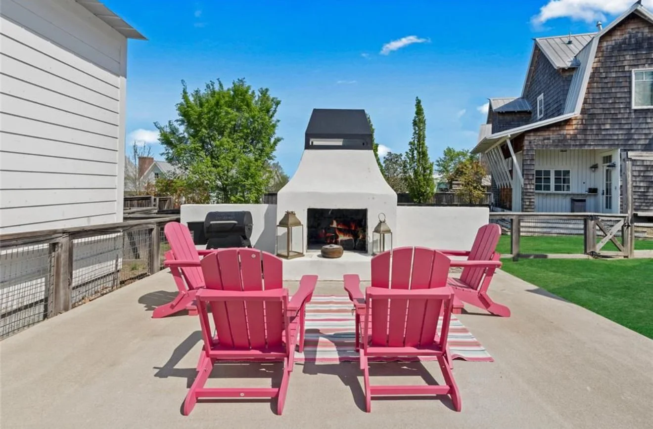 Private outdoor fire pit with pink Adirondack chairs near Pink Firefly Cottage in Carlton Landing