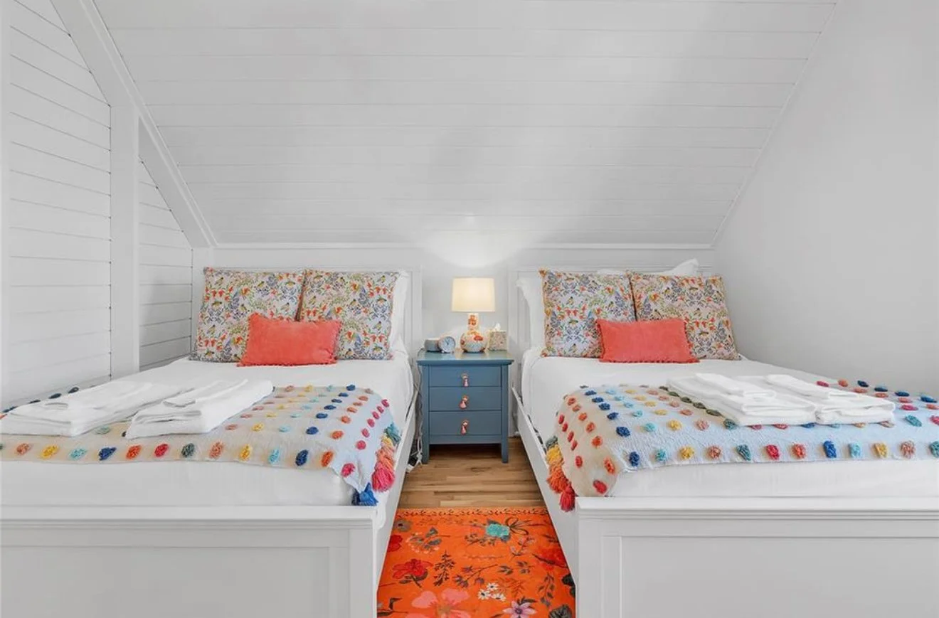 guest bedroom with double beds at Pink Firefly Cottage Lake Eufaula vacation rental Carlton Landing