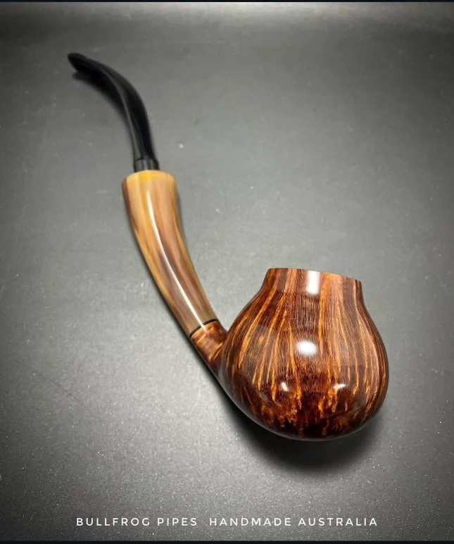 Handmade wooden smoking pipe with a curved black mouthpiece on a black background, labeled 'Bullfrog Pipes Handmade Australia'.