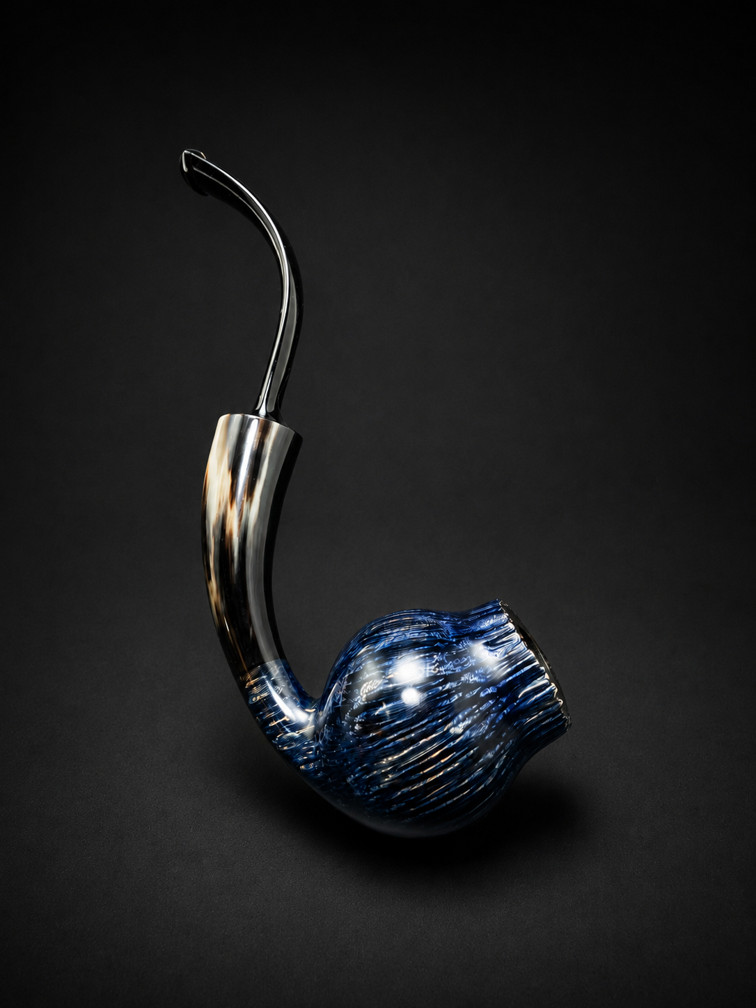 A glass artistic pipe with a curved neck and rounded bowl on a dark background.