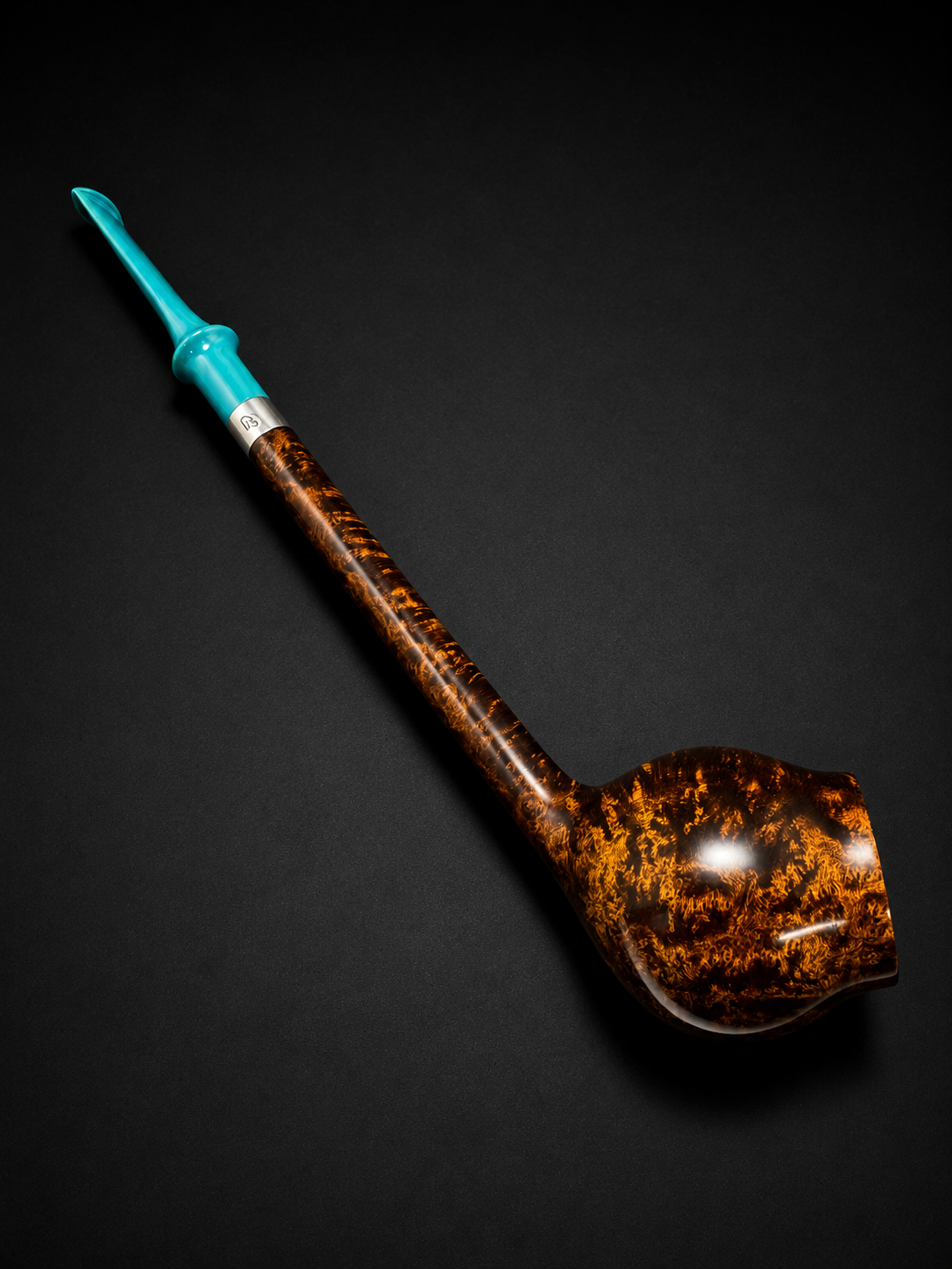 A smoking pipe with a blue acrylic stem and a brown, marbled bowl on a black surface.