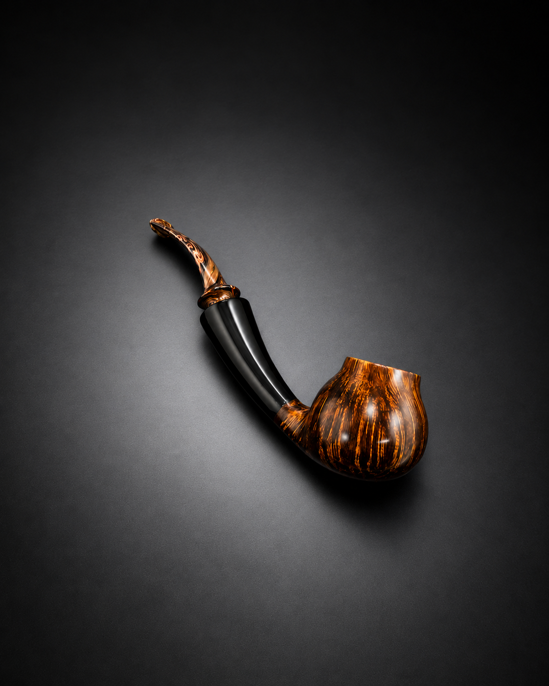 A decorative smoking pipe with a black stem and a brown marbled bowl, set on a dark surface.