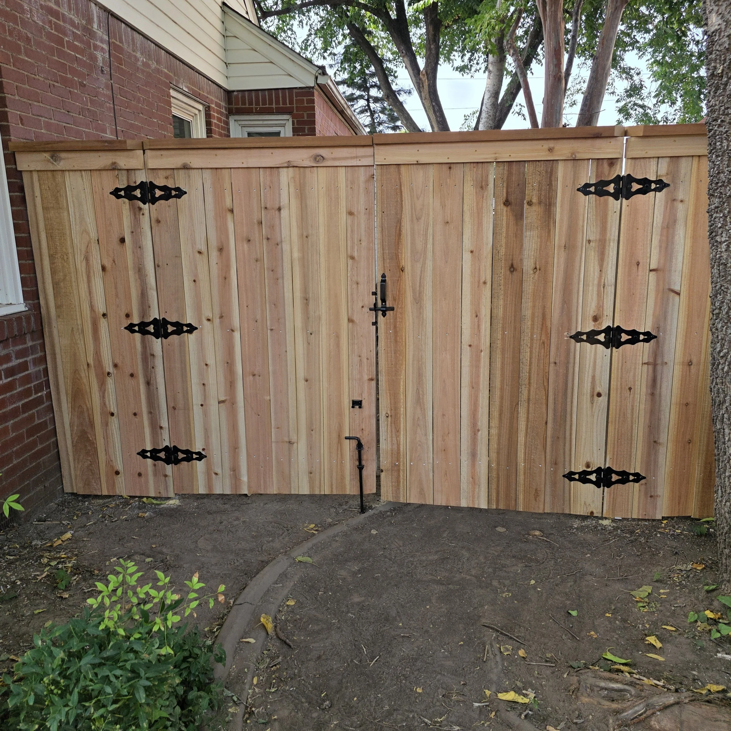 Completed custom double gate capped and trimmed by The Fence Guy