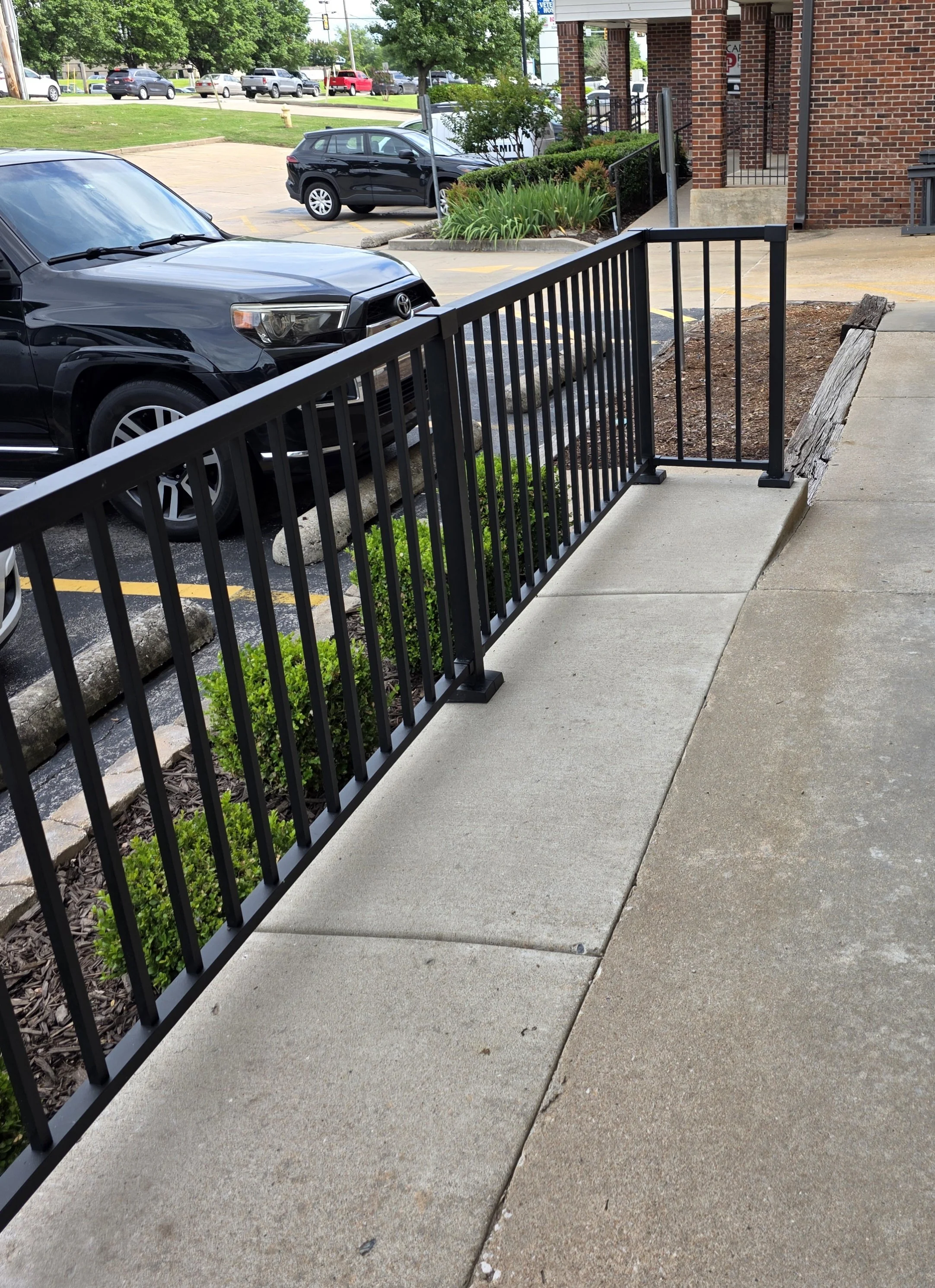 Black commercial railing installed by The Fence Guy in Tulsa, Oklahoma