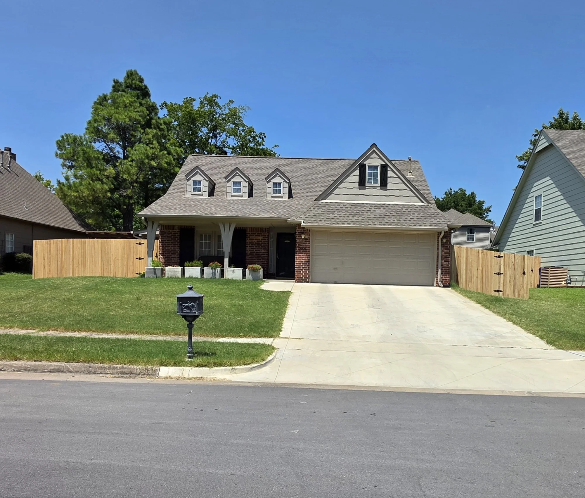 A wood privacy fence installed at a residential property by The Fence Guy in Broken Arrow, Oklahoma