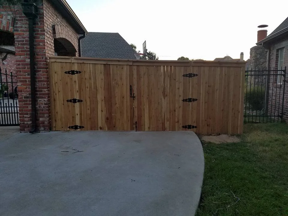 Custom double gate with steel posts at a residential property