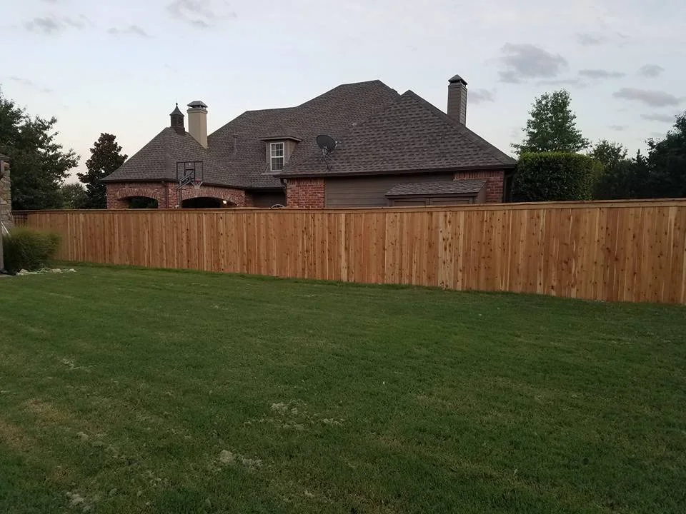 6' cedar privacy fence with cap installed at a residential property