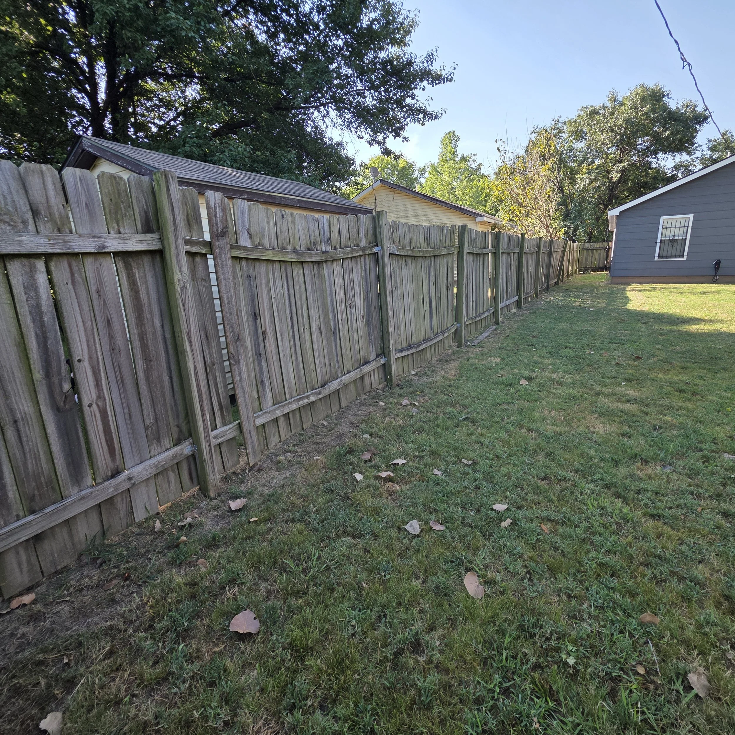 An old fence awaiting replacement by The Fence Guy in Tulsa, Oklahoma