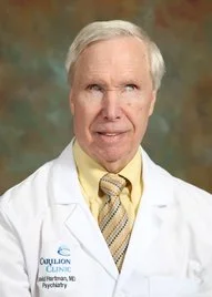 Dr. David Hartman or David W Hartman MD wearing his white coat that he pairs with a white cane in his work as a psychiatrist - a notable physician though blind