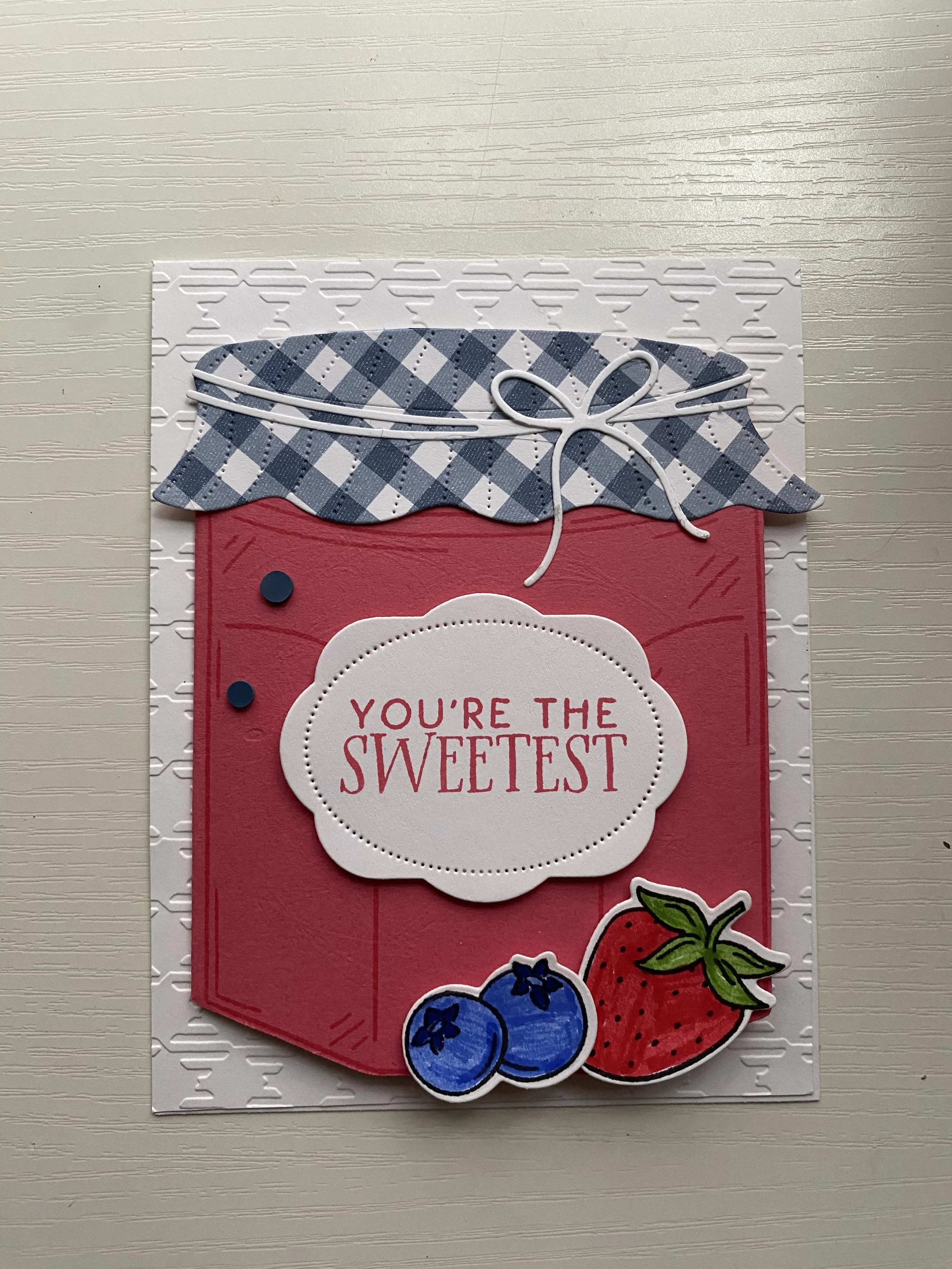 Colorful greeting card with strawberries and blueberries, containing a message that says, 'You're the sweetest'.