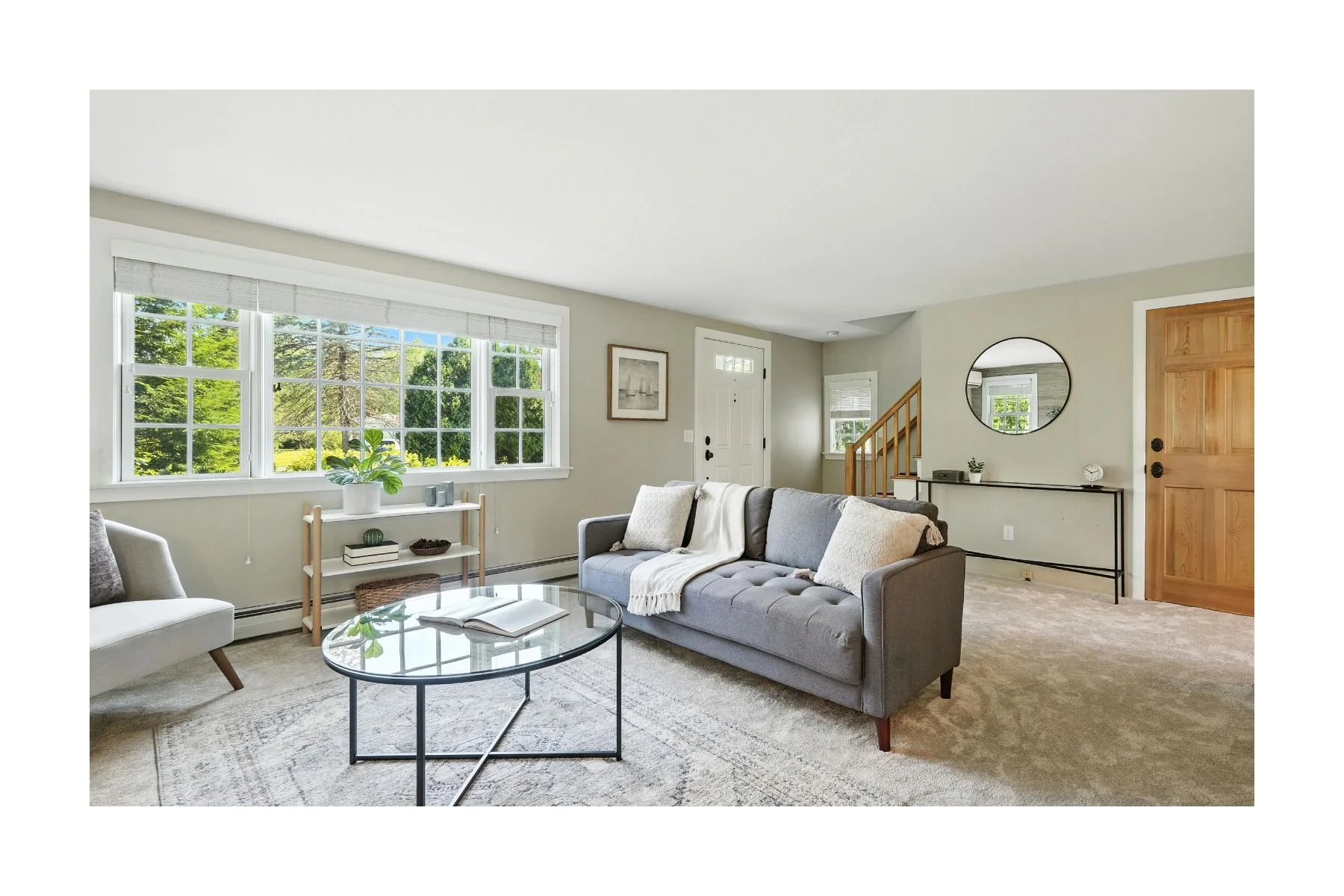 Professionally staged living room with natural light in an Amherst, MA home sold by Rhonda Cohen.