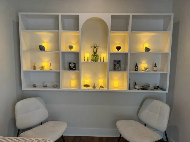 Meditation and energy-work room at ELEVATE in Lyons, Georgia, with illuminated candles, crystals and two chairs.